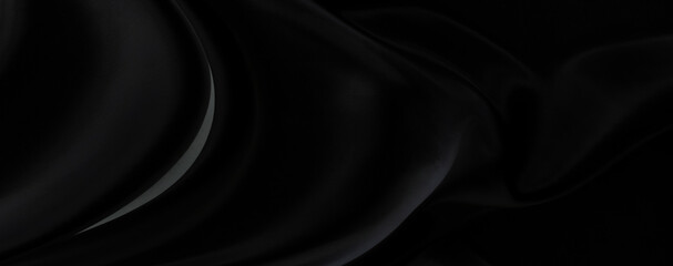 Black gray satin dark fabric texture luxurious shiny that is abstract silk cloth panorama background with patterns soft waves blur beautiful.