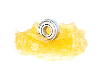 Ball bearing with yellow grease on white background