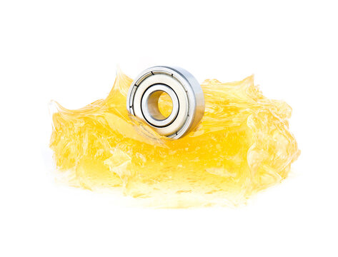 Ball Bearing With Yellow Grease On White Background