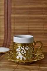 gold cup for coffee on a light background