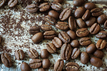 coffee beans are scattered on a wooden background