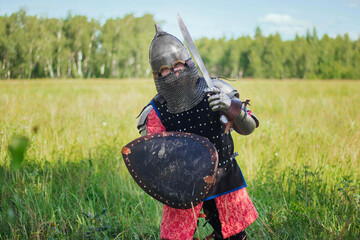 A medieval Central Asian warrior, a nomad in 14th-century armor, stands in a defensive or attacking...