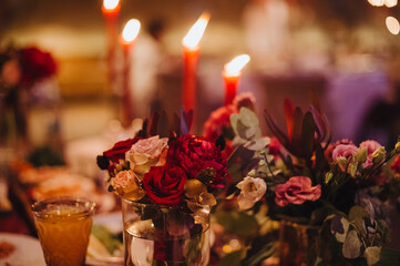 Composition of flowers of pink, white, rose, hydrangea. Candles, crystal, garlands. Decor wine and marsala colors