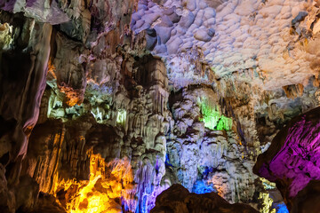 Stalactite and stalagmite formations in a limestone cave of Halong Bay, Vietnam