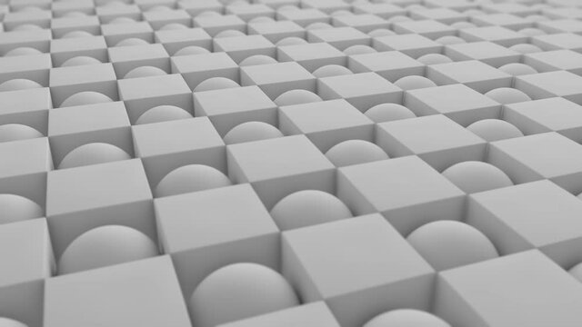 Abstract 3D animation of a geometric background of many spheres and cubes in a staggered order. Cubes turn into spheres and spheres turn into cubes. 4K seamless animation.