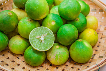 Lemon in basket on white wood.