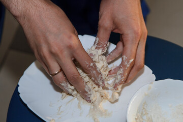 raw dough chef kneads his hands on the table