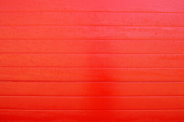 red wooden background textured from painted red boards