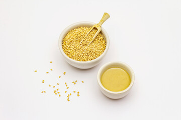 Tahini with sesame seeds isolated on white background