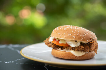 burger on a plate with blurred background
