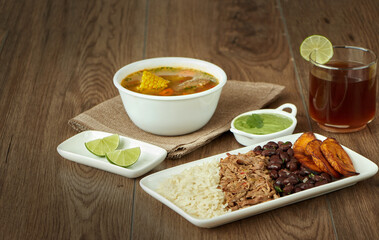 Venezuelan and Colombian food varied, arepa, tostones, patacon, sancocho, beef soup, pabellón criollo with papelon con limon
