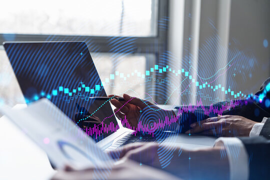 Two business people working together on stock market strategy. Try to analyze forex behavior. Financial graph hologram. Double exposure. - Powered by Adobe