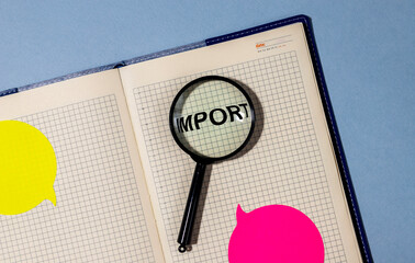 Magnifying glass with the word import on notebook planner with stickers on blue table. Searching...