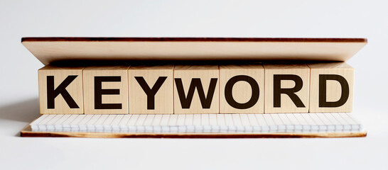 Innovation word wood block KEYWORD on table for business concept.