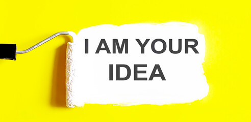 I AM YOUR IDEA . One open can of paint with white brush on it on yellow background. Top view. Repairing concept.