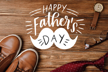 Top view of mens beige casual shoes, polka dots red tie, wristwatch and glasses on wooden background, happy fathers day illustration