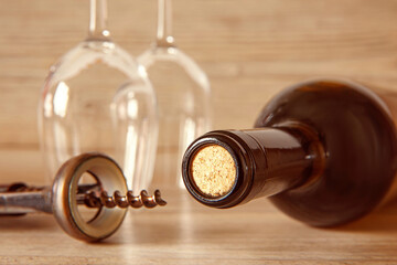 Glass bottle of wine, two glasses and a corkscrew