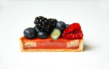 Texture inside of a tart. French dessert. Berry tart decorated with organic fresh blueberries, raspberries and blackberries. Back view. There is a copy space for your text.