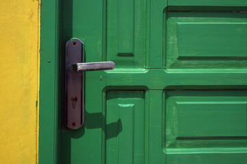 light green door with metal handle 
