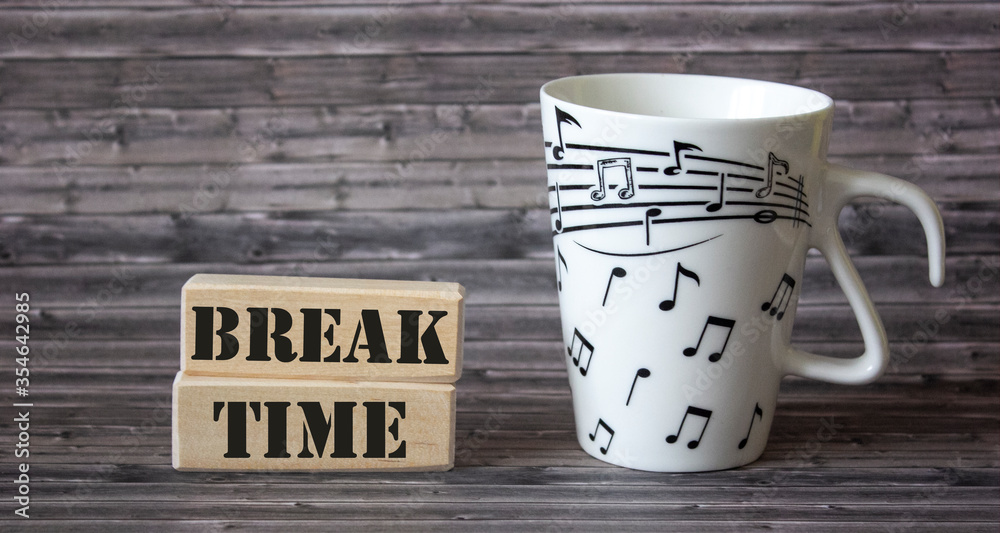 Fototapete time for a break text on blocks with a mug on a wooden table