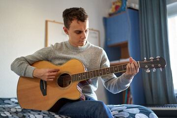 Teenage boy playing guitar