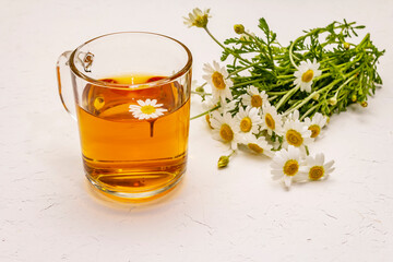 Chamomile tea. Fresh flowers, summer hot drink concept. Alternative medicine, lifestyle