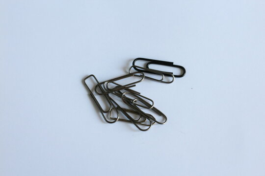 several metal clips on a white table