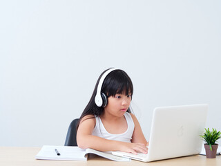 Little girl doing online class.