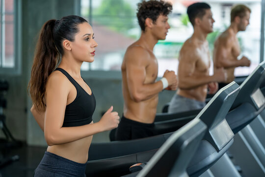 Group of young people running on treadmills in modern gym,Fitness exercise and healthy concept.