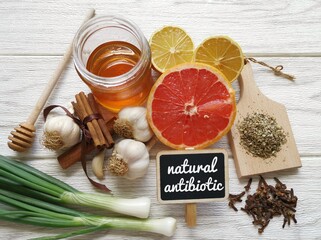 Foods high in antibiotics. Healthy foods with antibacterial properties. Assortment of food protecting against infection. The best natural antibiotic: honey, lemon, garlic, oregano, clove, grapefruit.