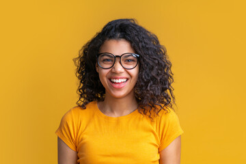 Studio shot of cute african american girl on bright yellow background