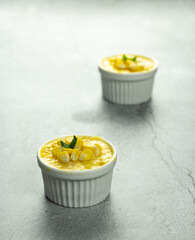 Homemade sweet corn custard dessert in ramekin over light background