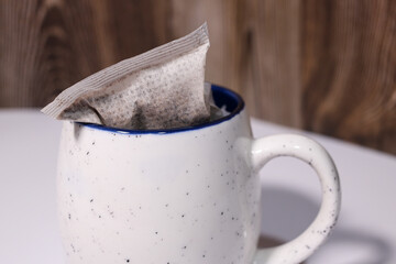 a cup and a coffee tea bag