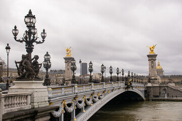 Fototapeta na wymiar Photo of the Alexander III bridge in Paris during a cloudy day