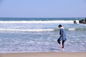 A young man by the waviness. Background,coast,blue,wave.
