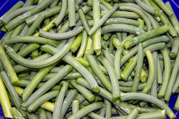 Green arrows of young garlic. Fresh cut into oblong pieces. Cooking a vegetarian southern dish.