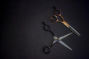 Hairdressing scissors. Couple. For haircuts, black and open-cut filings, rose gold. Solid black background. Base, banner, postcard.