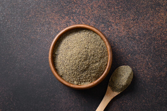 Organic dried hemp flour in wooden bowl. Useful vegetable protein for vegans and source of vitamins from safe varieties. View from above. Healthy ingredient for bakery.