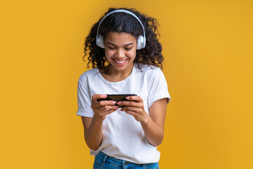 Studio shot of cute african american girl on bright yellow background
