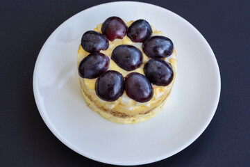 The legendary Tiffany layered salad with grapes, chicken and cheese on the black background.