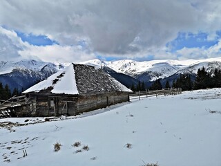 Wooden shelter / sheepfold in the mountains during winter. Winter landscape in the mountains .
