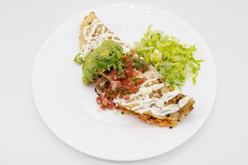 Chicken Quesadilla with Guacamole and Pico de Gallo on a White Plate