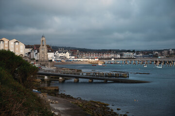 Morning city view in the south of England on the shore of a sea bay with a pier and boats. Swanage Bay, United Kingdom