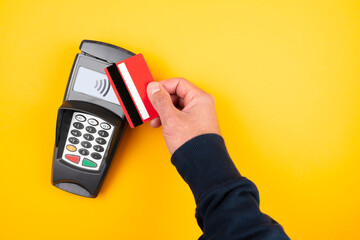 contactless payment concept, directly above view of person holding credit card or debit card...