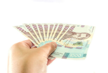 new 1000 hryvnia in hand isolated on white background. A lot of hryvnia.