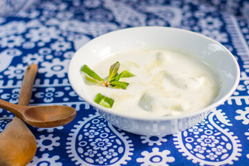 Georgian traditional food Gebjalia, cheese in milk and greens, species.