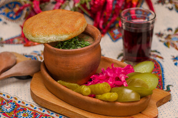 Georgian traditional food Lobio or kidney and haricot beans soup with picked vegetables and red wine.