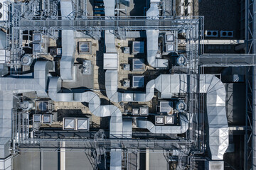 Fototapeta premium Air Condition Ventilation System on the Building Roof. Industrial Air system of ventilation and Air conditioning. Aerial Shot.