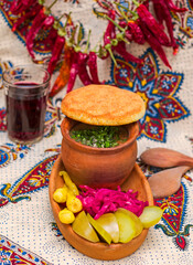 Georgian traditional food Lobio or kidney and haricot beans soup with picked vegetables and red wine.