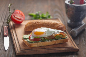 Fototapeta na wymiar Sandwich with vegetables and eggs, vegetables and greens